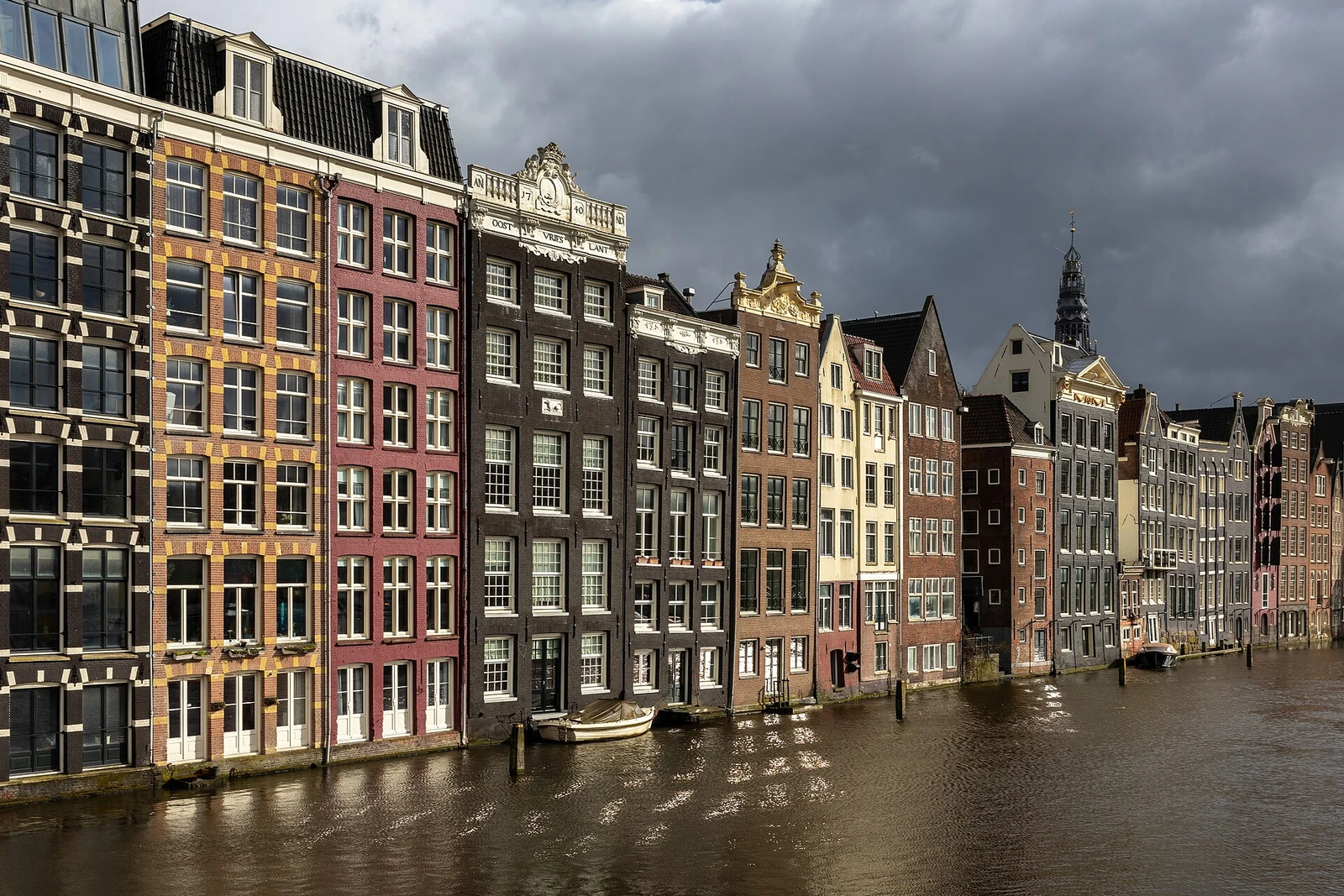 Colorful canal houses at golden hour in Damrak avenue Amsterdam the Netherlands.jpg